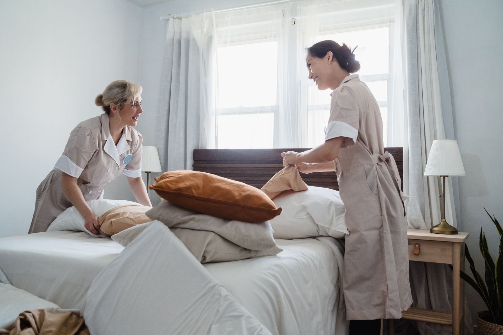 Two Crisp & Co. technicians working together in a bedroom